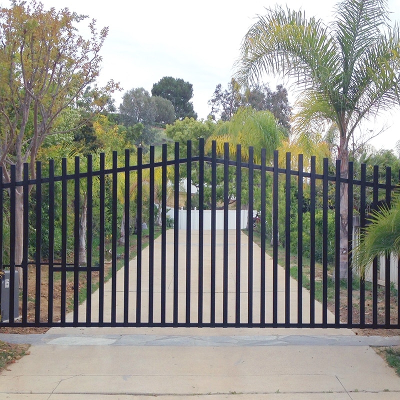 Photo of an ornamental iron gate protecting a driveway on a residential property.
