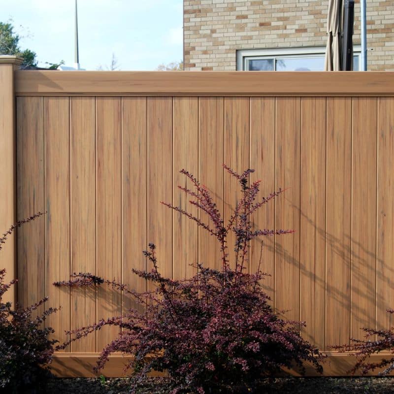 A brown privacy fence in a residential backyard installed by our Foothill East, Ventura vinyl fence contractors.