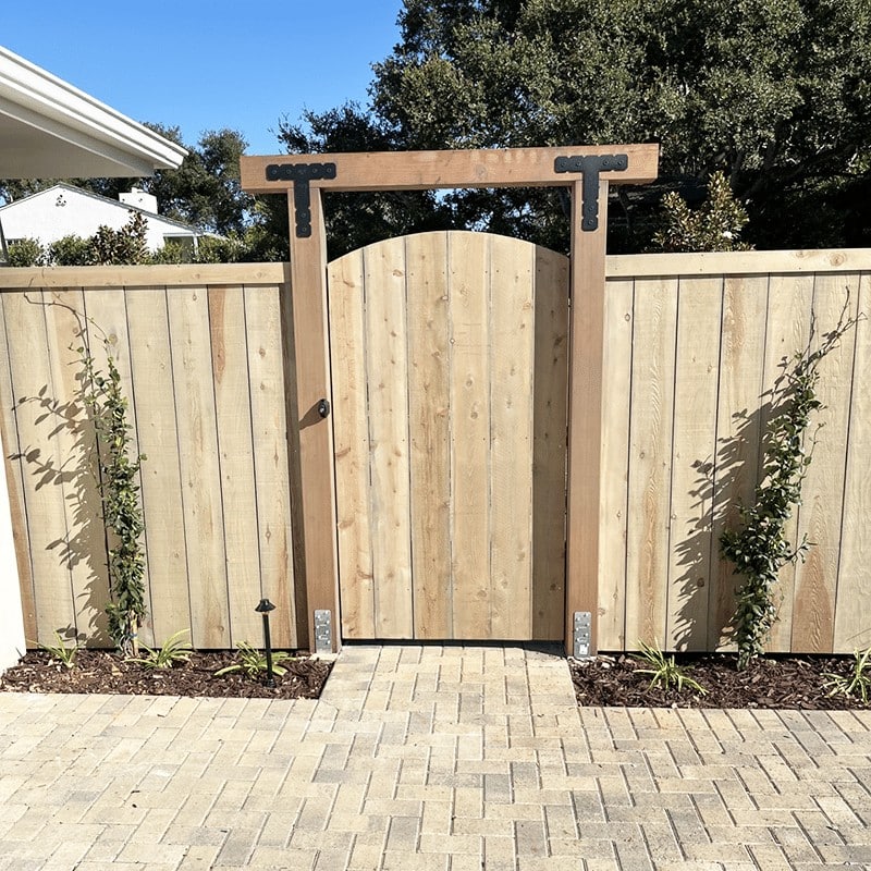 A wood privacy fence with central gate, built with Fence Factory's fence materials for sale near Santa Barbara, California.
