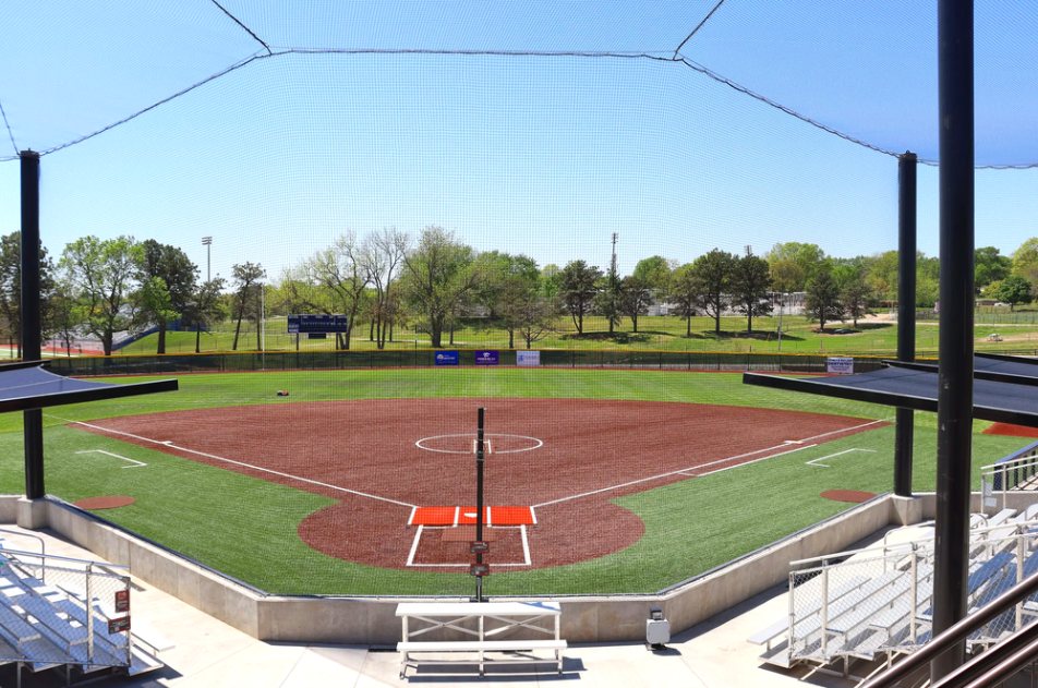 Backstop netting system behind home plate with bleachers