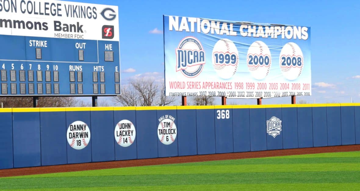 Custom branded outfield wall padding and scoreboard