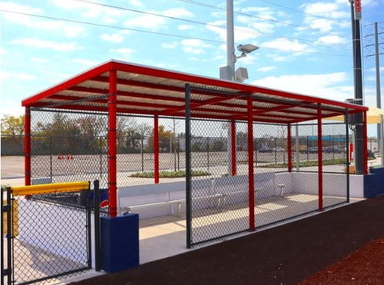 Covered dugout with red steel frame
