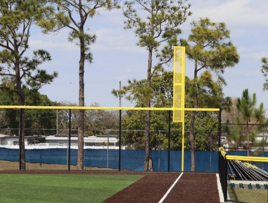 Yellow foul pole on an outfield fence