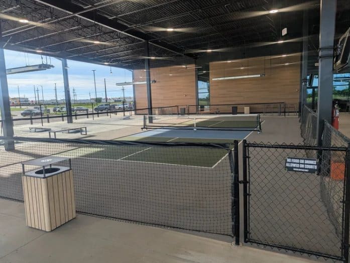 Covered pickleball courts with divider netting