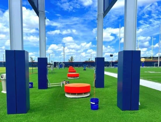 Padded structural poles on a turf field